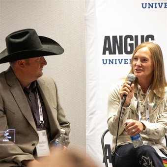 A young couple speaks during an Angus University session about their commercial herd.
