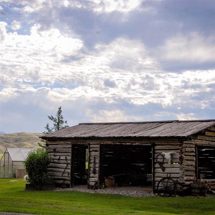 Homestead cabin in valley of mountains