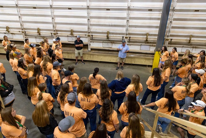 A large group of NJAA members listening to a speaker in a warehouse area during the 2023 LEAD Conference.