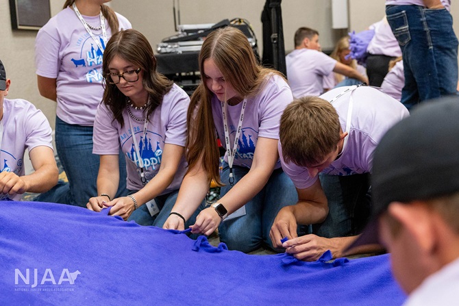 Participants assembling a no-sew blanket for Project Linus.