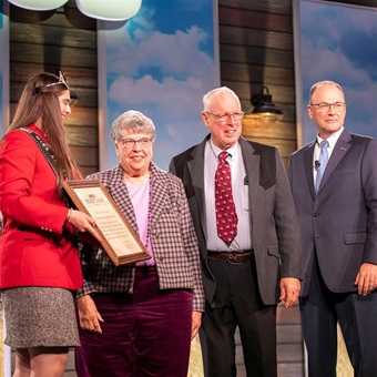 An older couple receives an award at the American Angus Association Annual Convention awards dinner.