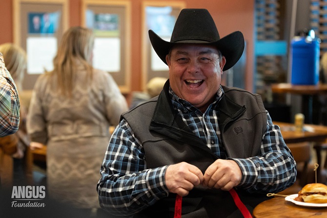 An Angus member counts his raffle ticket numbers at the NWSS Social hosted by the Angus Foundation.