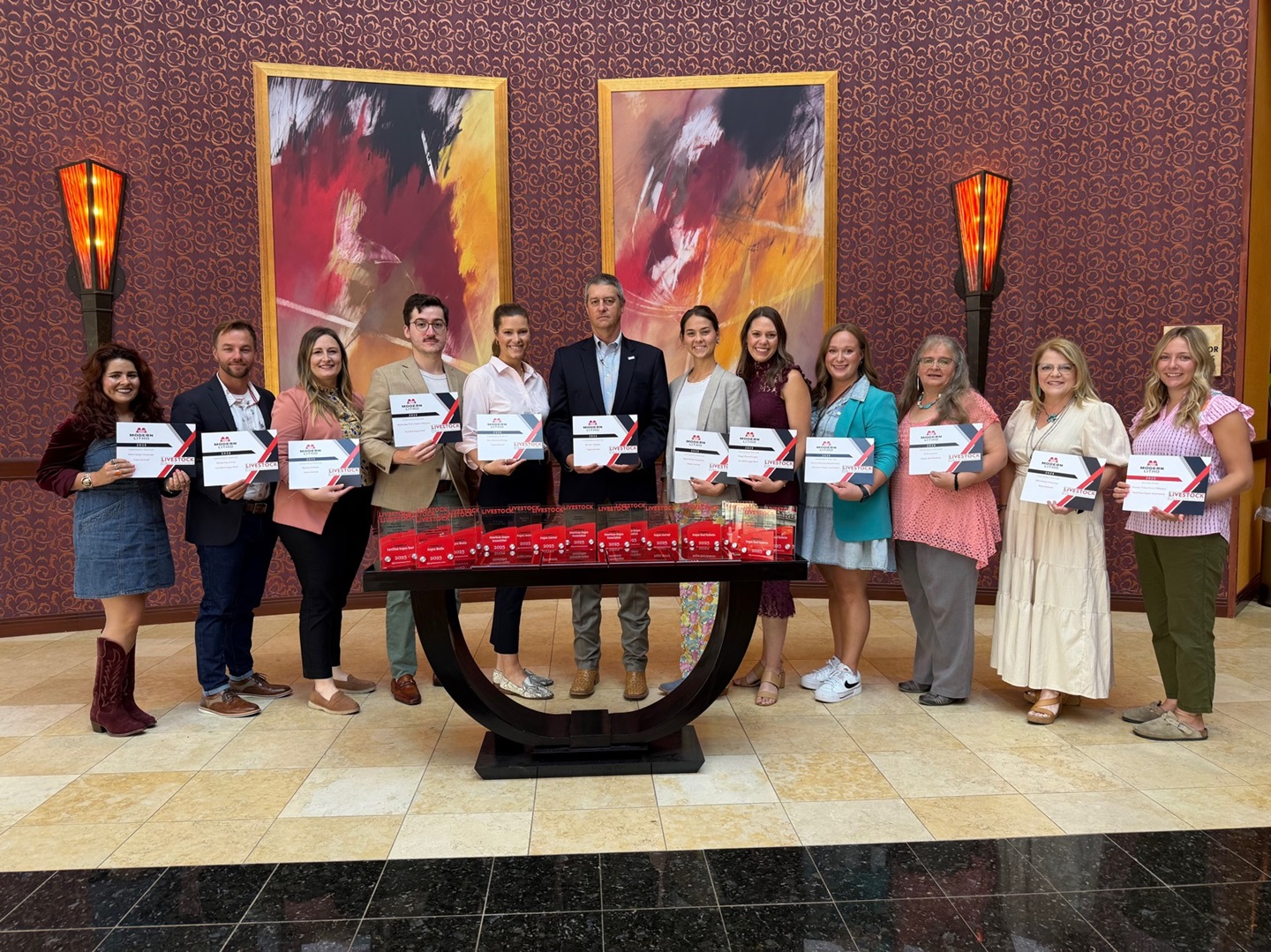 Angus employee group photo with awards.