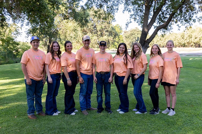 Group of NJAA members standing together wearing matching orange event t-shirts.