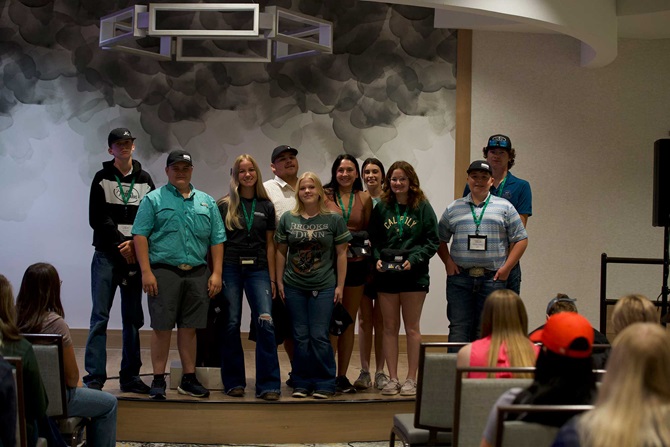 A small group of NJAA members standing at the front of a lecture hall after receiving recognition of their participation in events at the 2023 LEAD conference.