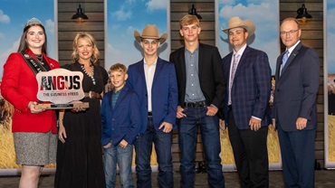  Josh Worthington accepts his award on November 1 for 2025 Young Breeder of the Year on stage in Kansas City, Missouri during Angus Convention. Pictured from Left: Rosalind Kidwell, 2025 Miss American Angus; Corry Worthington, wife; sons Corbin, Grayson and Wriston Worthington; Josh Worthington; and Mark McCully, American Angus Association® CEO. 