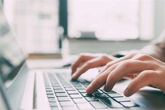 A person typing on a computer.