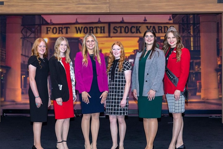 The 2024-2025 Miss American Angus candidates standing on the convention state to be recognized.