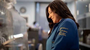 Girl wearing lab coat in science lab.