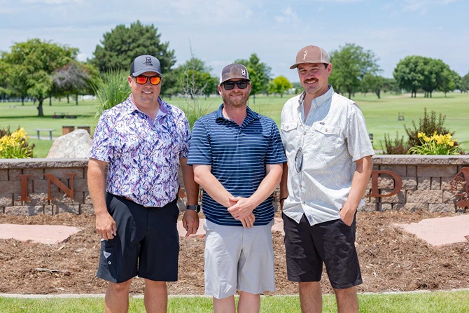 Group of three men on a golf tournament team.