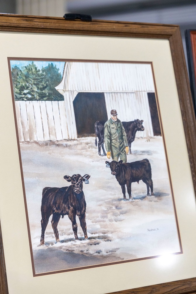 A framed drawing of a farmer feeding two Angus calves near a barn  was sold in the Angus Foundation Silent Auction at the 2025 NJAS event.