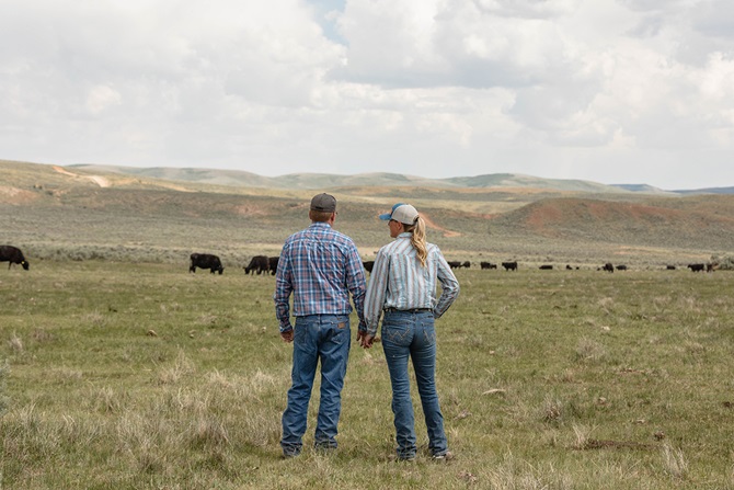 two people looking at their herd