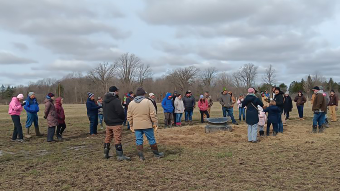Attendees tour the winter-feeding site at St. Anastasia Farms pasture walk. [Photo by Michelle Sweeten, Michigan State University Extension.]