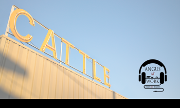 Sign reading 'cattle' above building.