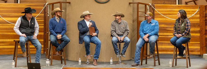 Group of cattlemen discussing beef industry topics as part of a panel.
