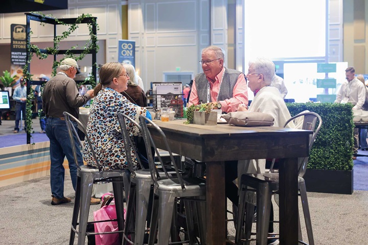 Convention goers catching up during welcome reception in the Angus Association booth. 