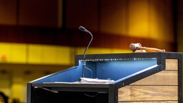 An up-close image of a podium at a conference center and a microphone.