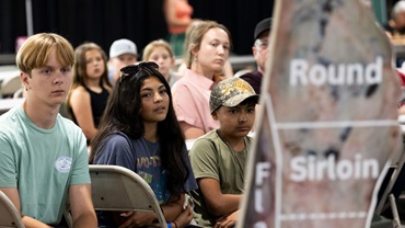 Luke Summers, Penelope Soto and Benjamin Soto listen intently to Gretchen Mafi, Oklahoma State University professor of animal and food science, present on meat quality during the 2025 National Junior Angus Show carcass clinic in Tulsa, Okla.