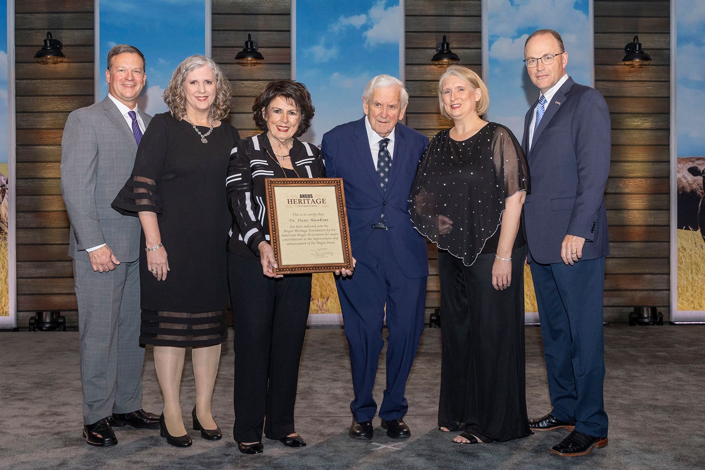 Dr. David Hawkins, Mason, Michigan, was inducted into the Angus Heritage Foundation at the 2025 Angus Convention on Nov. 1.    Pictured from left are Dan and Lisa Moser, son-in-law and daughter; Kathleen Hawkins, wife; Dr. David Hawkins; Jennifer Hawkins, daughter; and Mark McCully, American Angus Association CEO.  