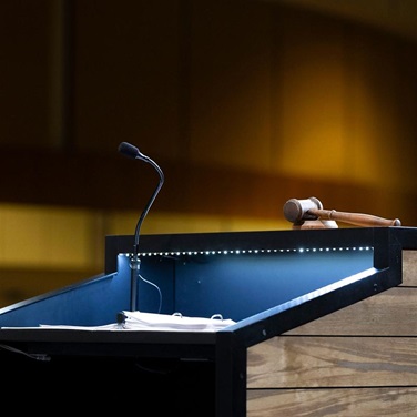 A podium lit up at the top of a stage.