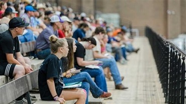 Group of students participating in a presentation or contest at the National Junior Angus Show.