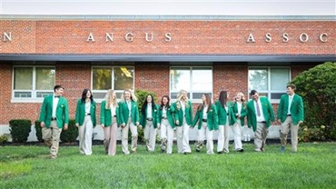 A group of NJAA board members in their official jackets walking in front of the American Angus Association office.