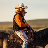 A couple sitting horseback.